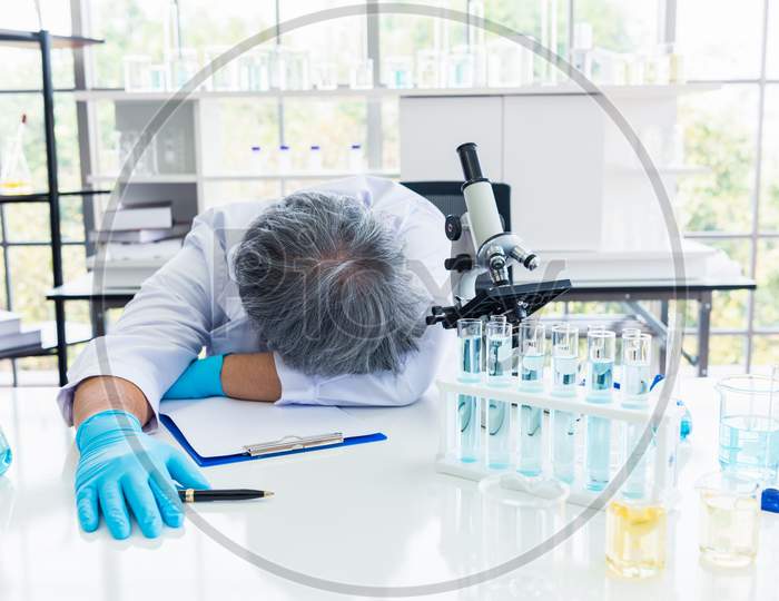 Exhausted Scientist Sleeping In Laboratory. People Lifestyles And Occupation Concept. Science And Experiment In Lab Theme.