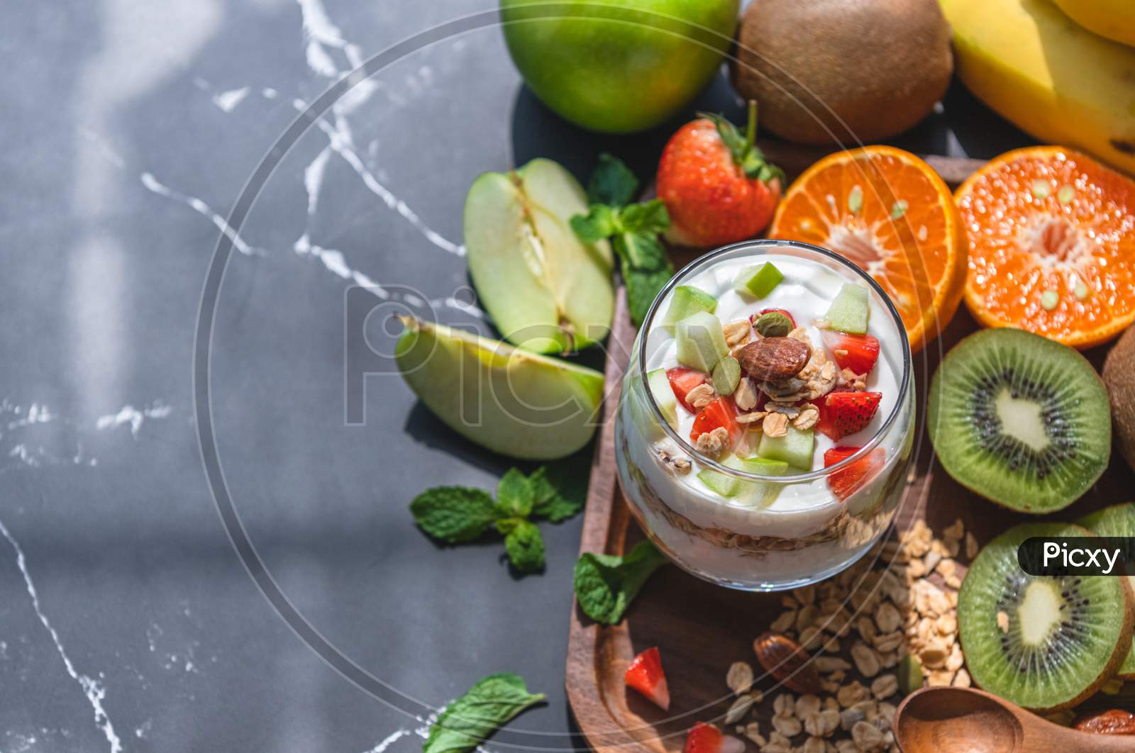 Closeup Nutrition Yogurt With Many Fruits On Table. Food Cuisine And Drinks Concept. Organic Dessert Theme.