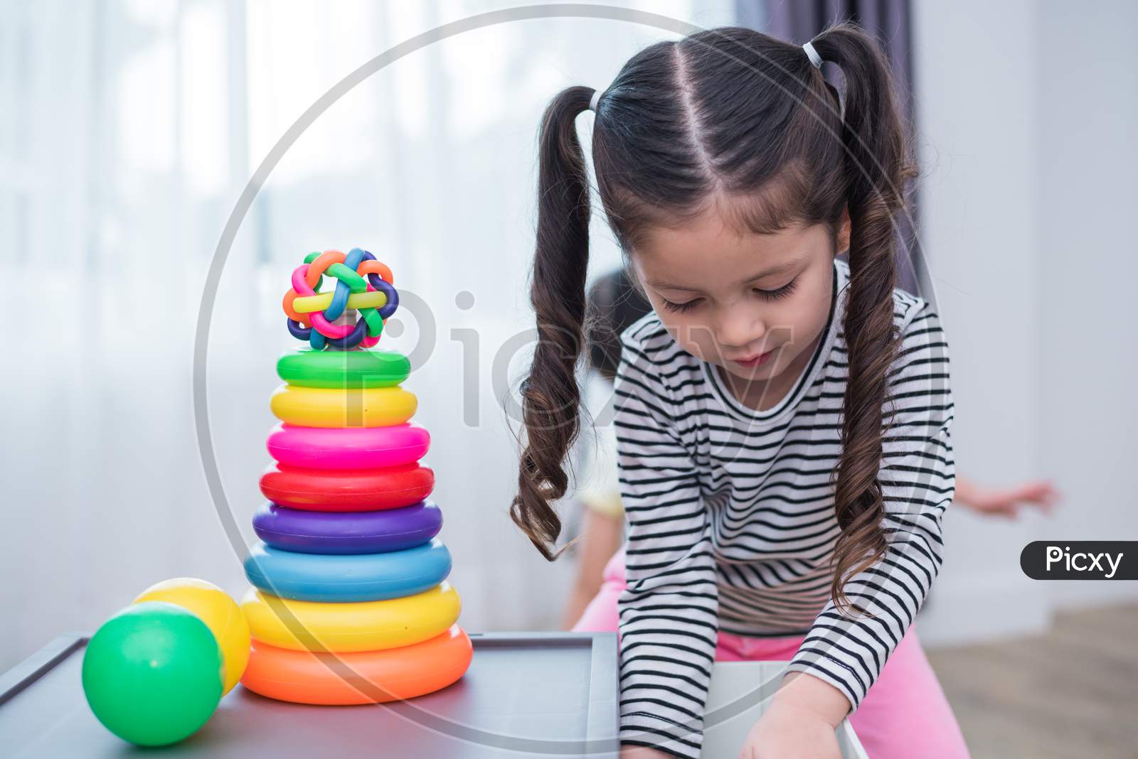 Little Girls Playing Small Toy Hoops In Home. Education And Happiness Lifestyle Concept. Funny Learning And Children Development Theme. Smile Faces