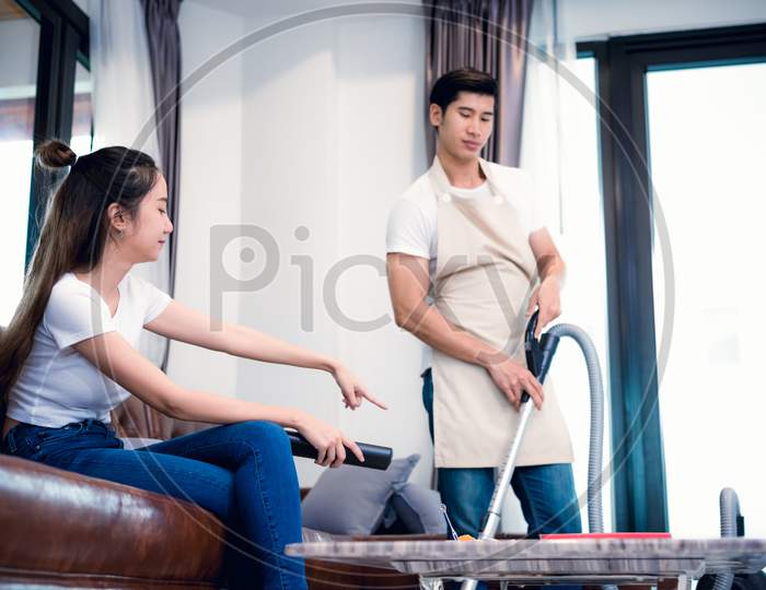 Girlfriend Force Ordering Boyfriend To Do Household Work By Vacuum Cleaner. Lovers And Couples Concept. Honeymoon And Wedding Theme. Interior And Dating Theme. Man Dissatisfy To Do Household Working