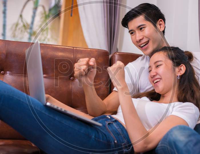 Asian Young Couples Using Laptop. Lovers And Couples Concept. Honeymoon And Wedding Theme. Interior And Dating Theme.