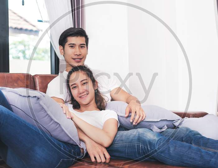 Sweet Free Time Together. Happy Beautiful Lovers Spending Weekend Together On Couch Or Sofa Indoors At Home, Relaxing And Enjoying On Couple Concept In Holidays