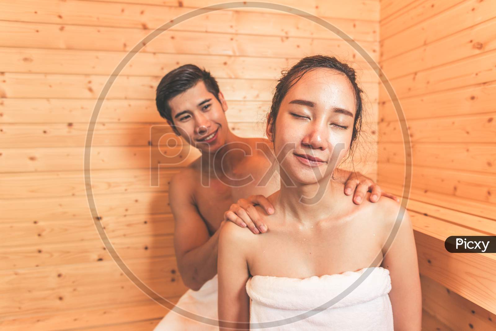 Young Asian Couples Or Lovers Have Romantic Relaxing In Sauna Room. Skin Care Heat Treatment And Body Clean Up And Refreshing In Spa With Steam Bath. Healthy And Honeymoon Concept. Happiness Together