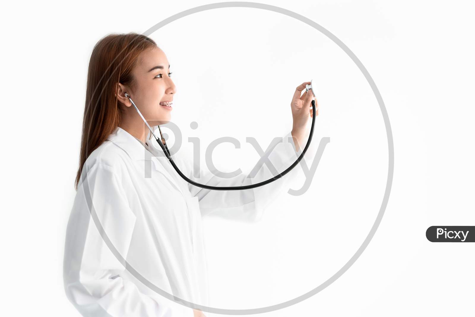 Female Doctor Is Holding Stethoscope And Hear Heart Beat Sound On White Isolated Background. Medical And Healthcare Concept. Hospital And People Theme