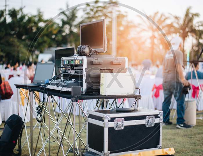 Dj Mixing Equalizer At Outdoor In Music Party Festival With Party Dinner Table. Entertainment And Event Organizer Concept. Concert And Musical Theme