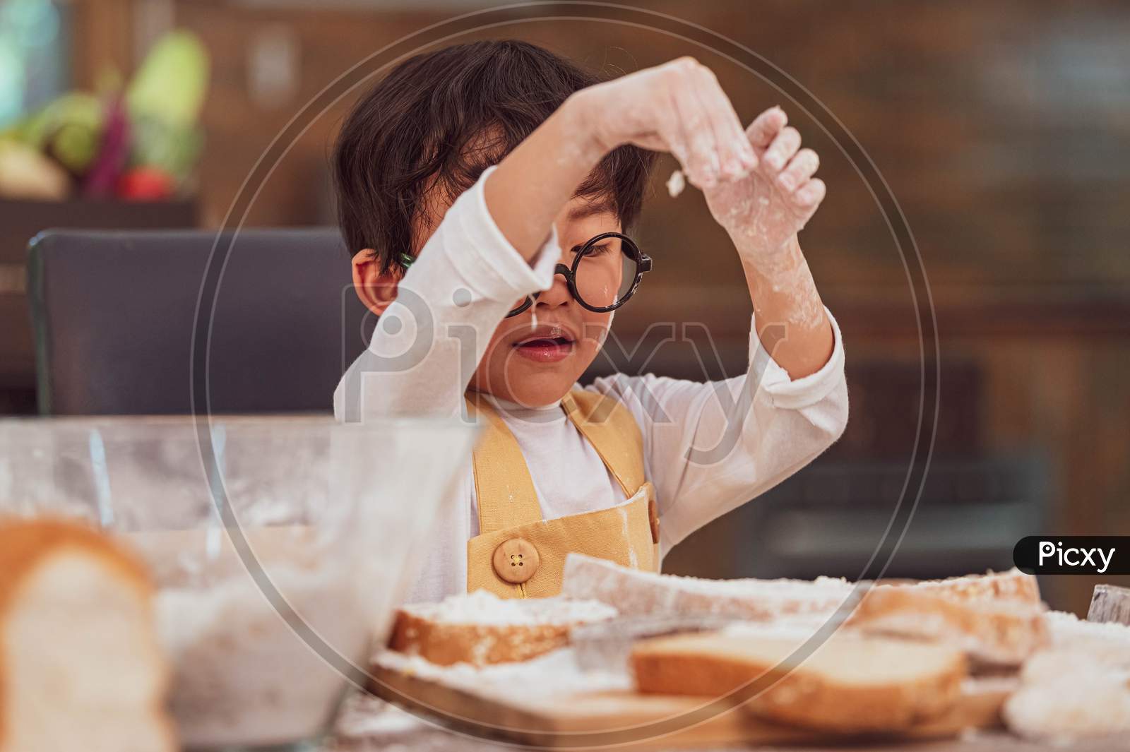 Portrait Cute Little Asian Happiness Boy Interested In Baking Bakery With Funny In Home Kitchen. People Lifestyles And Family. Homemade Food And Ingredients Concept. Baking Christmas Cake And Cookies