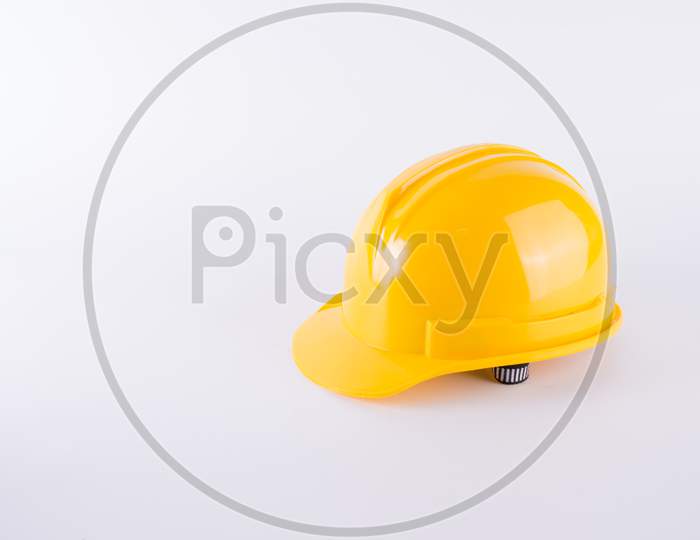 Yellow Safety Helmet On White Background. Hard Hat Isolated On White. Safety Equipment Concept. Worker And Industrial Theme.