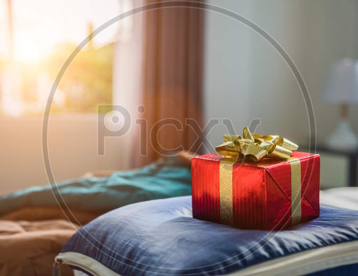 Gift Box In Bedroom. Holiday And Anniversary Day Concept. Birthday And Valentines Day Surprise Concept. Chirstmas And New Year Theme. Object And Decoration Theme.