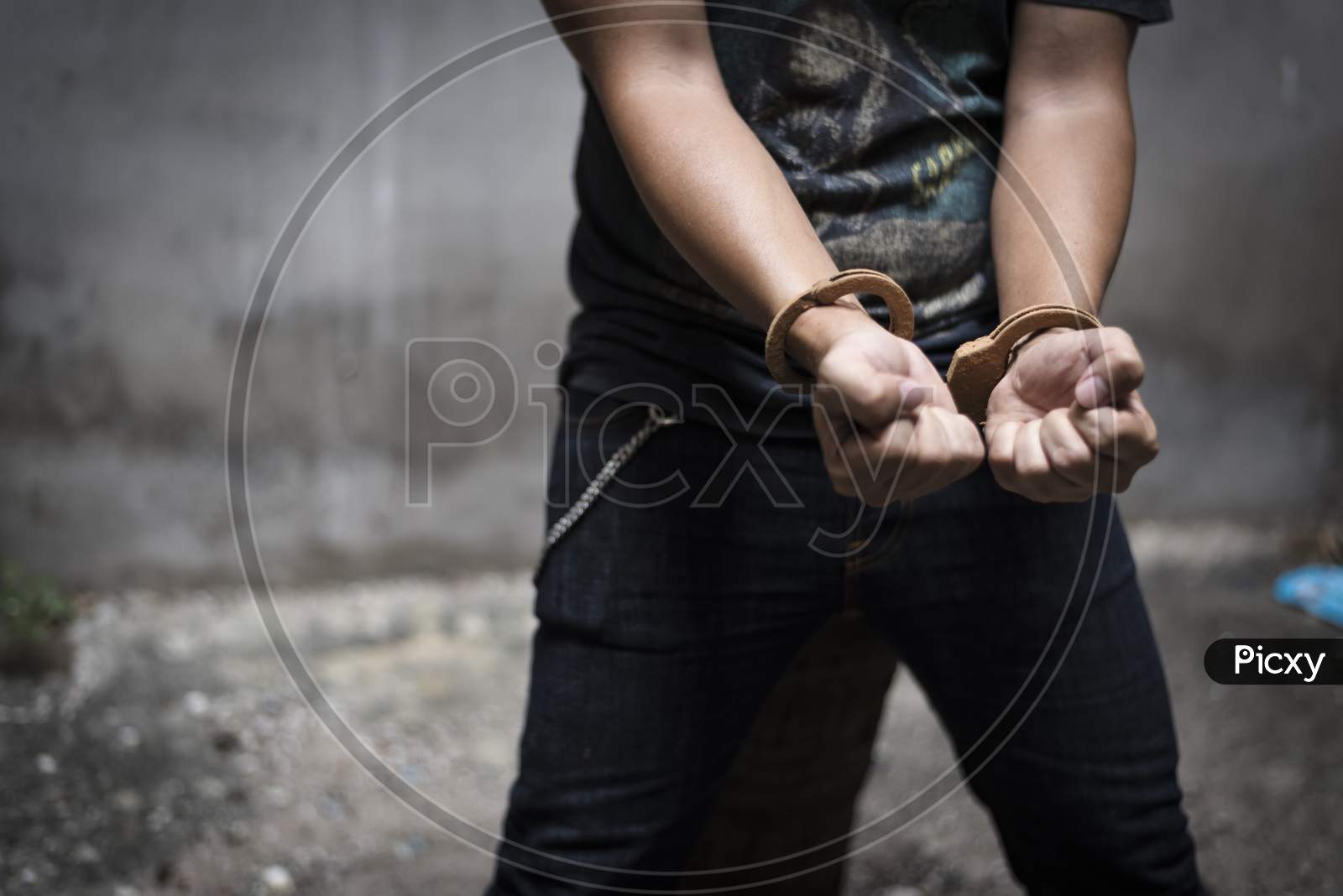 Handcuff With Prisoner In Jail, Criminal And Robber Concept. Dark Tone , Selective Focus On Handcuff