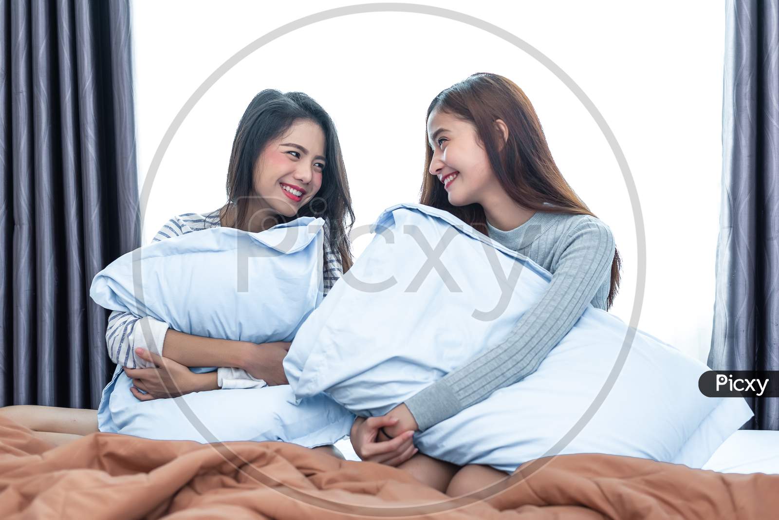 Two Asian Lesbian Looking Together In Bedroom.Beauty Concept. Happy Lifestyles And Home Sweet Home Theme. Cushion Pillow Element And Window Background. Lgbt Pride Theme.