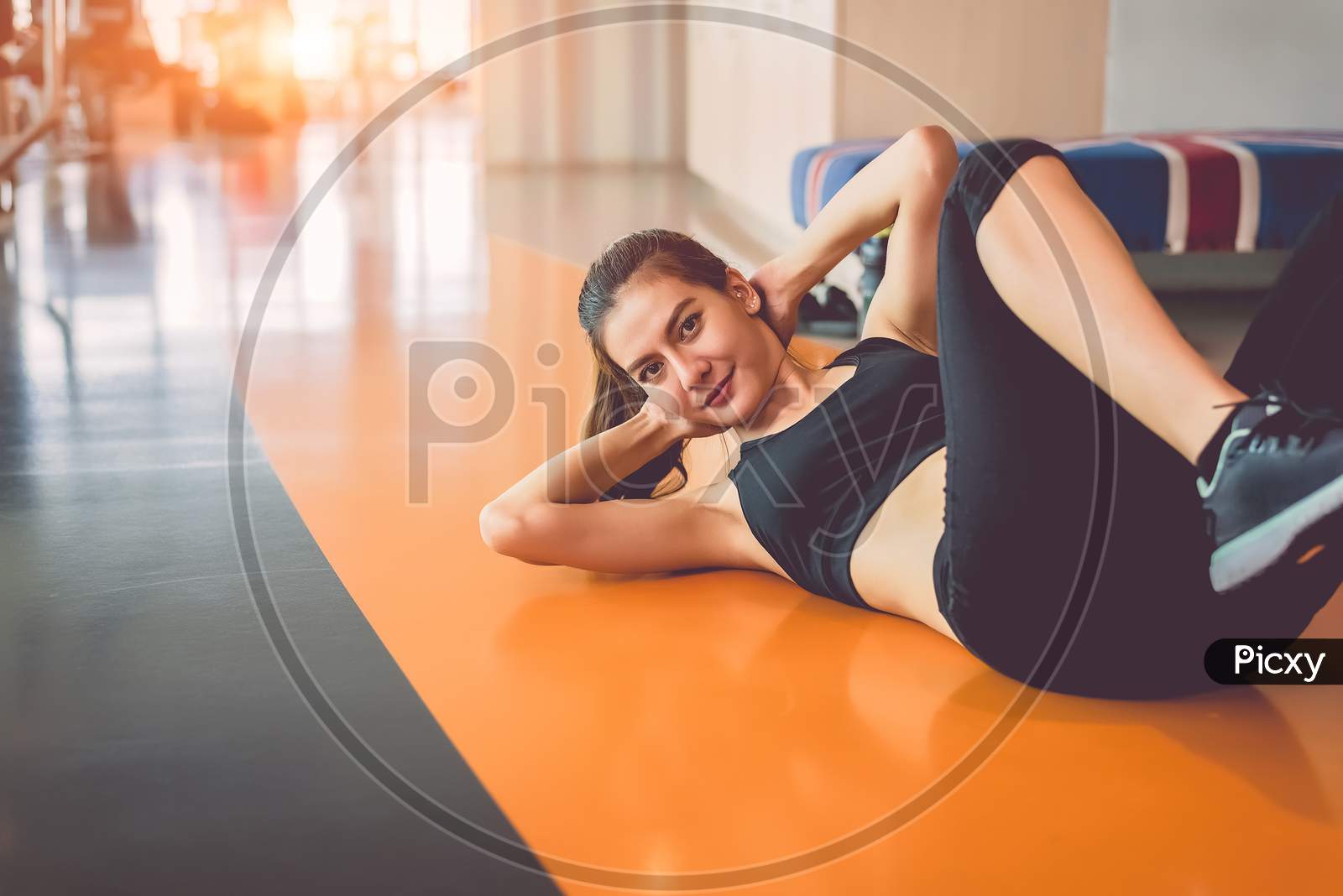 Sport Woman Doing Sit Up In Fitness Sport Training Club With Sport Equipment And Accessories Background. Workout Crunch And Bodybuilder. Lifestyles Leisure And Indoors Activity. Cardio Program Concept