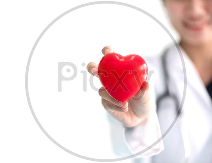 Close Up Of Female Doctor With Red Heart. Medical And Healthcare Concept
