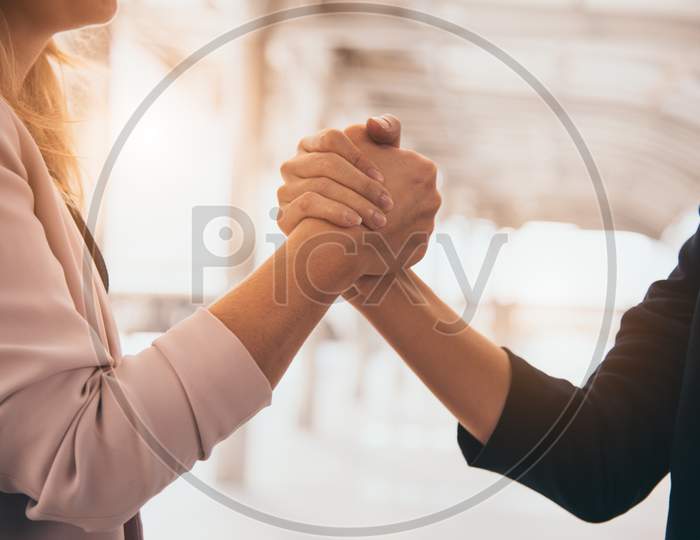 Business Partnership Meeting Trust Handshaking Concept. Businesswomen Doing Arm Wrestling. Successful Business People Contract Promise For Good Confidence Dealing With Skyscraper Building Background