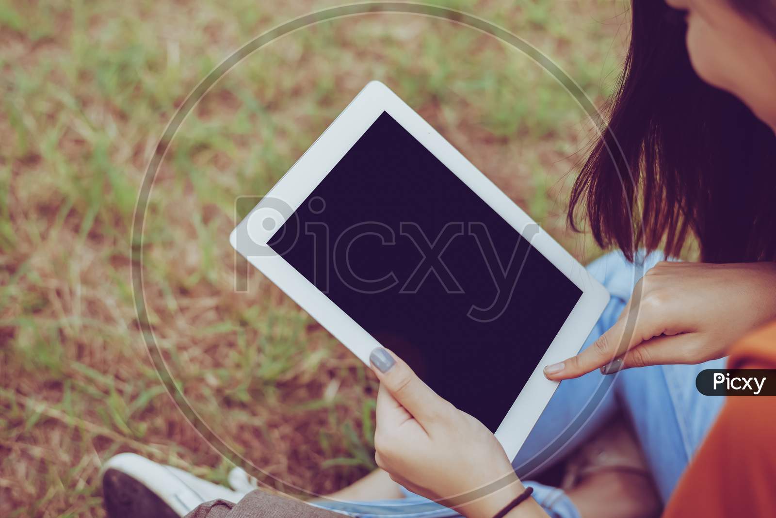 Beauty Asian Woman Using Tablet At Park. People And Technology Concept. Leisure And Outdoor Activity Theme.