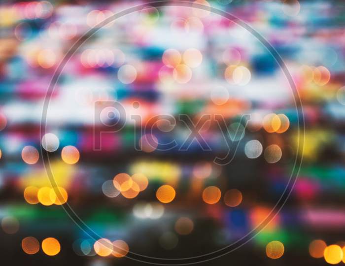 Blurry Background Of Night Market. Abstract And Decoration Lighting Concept. Christmas And New Year Theme.