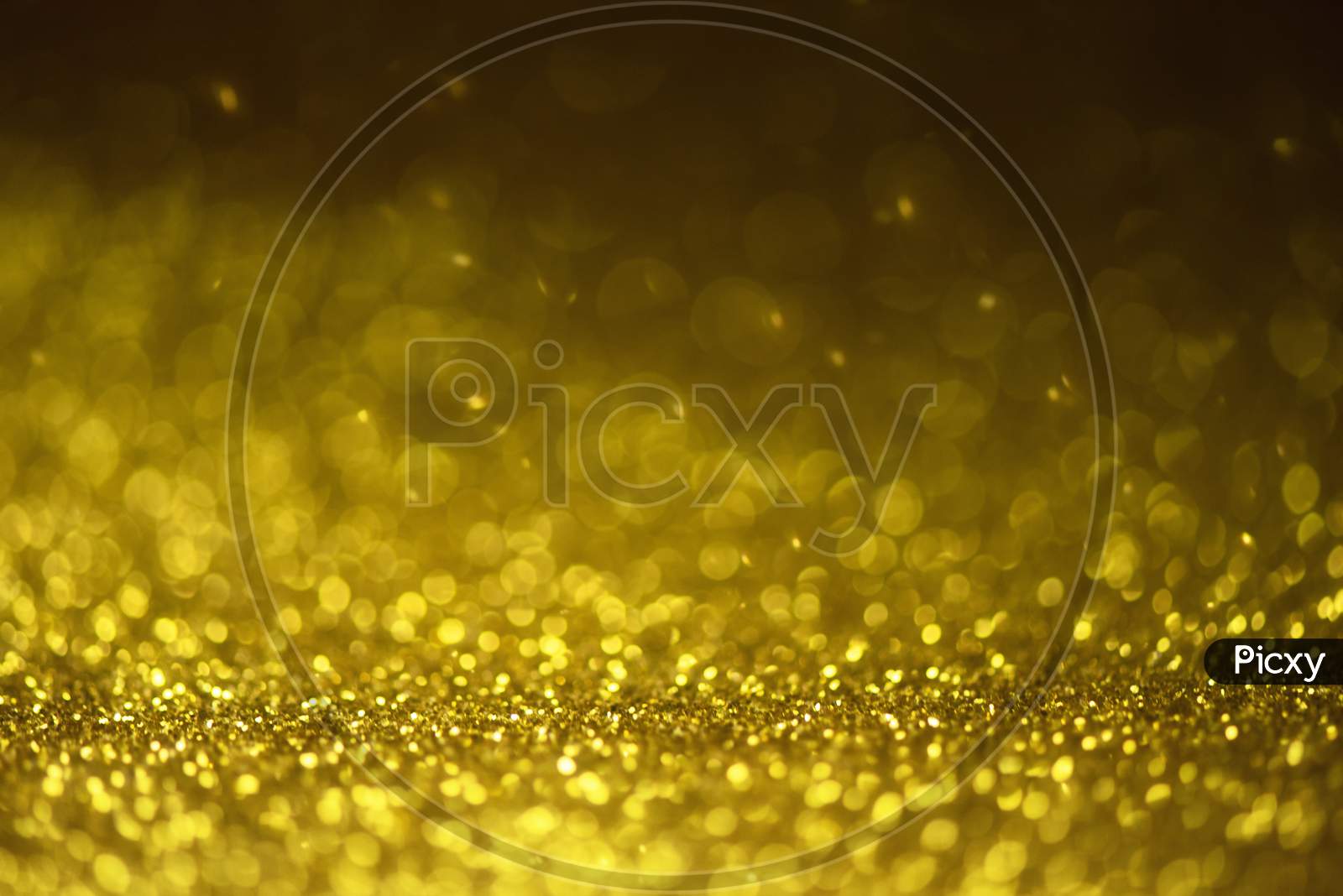 Gold Glitter Sparkle Lights Background. Defocused Glitter Abstract Twinkly Light And Shiny Stars. Christmas And New Year Party Concept Background. Closeup Stardust.