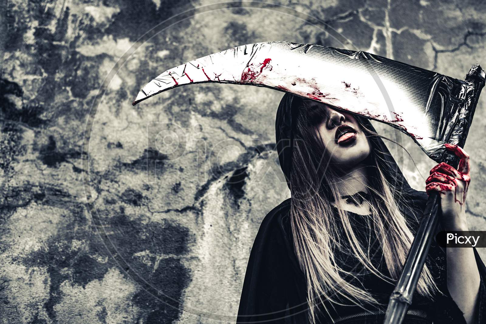 Image of Demon Witch Licking Blood On Reaper. Female Demon Angel In Black  Clothes And Hood On Grunge Wall Background. Halloween Day And Mystery  Concept. Fantasy Of Magic Theme. Afterlife And Death