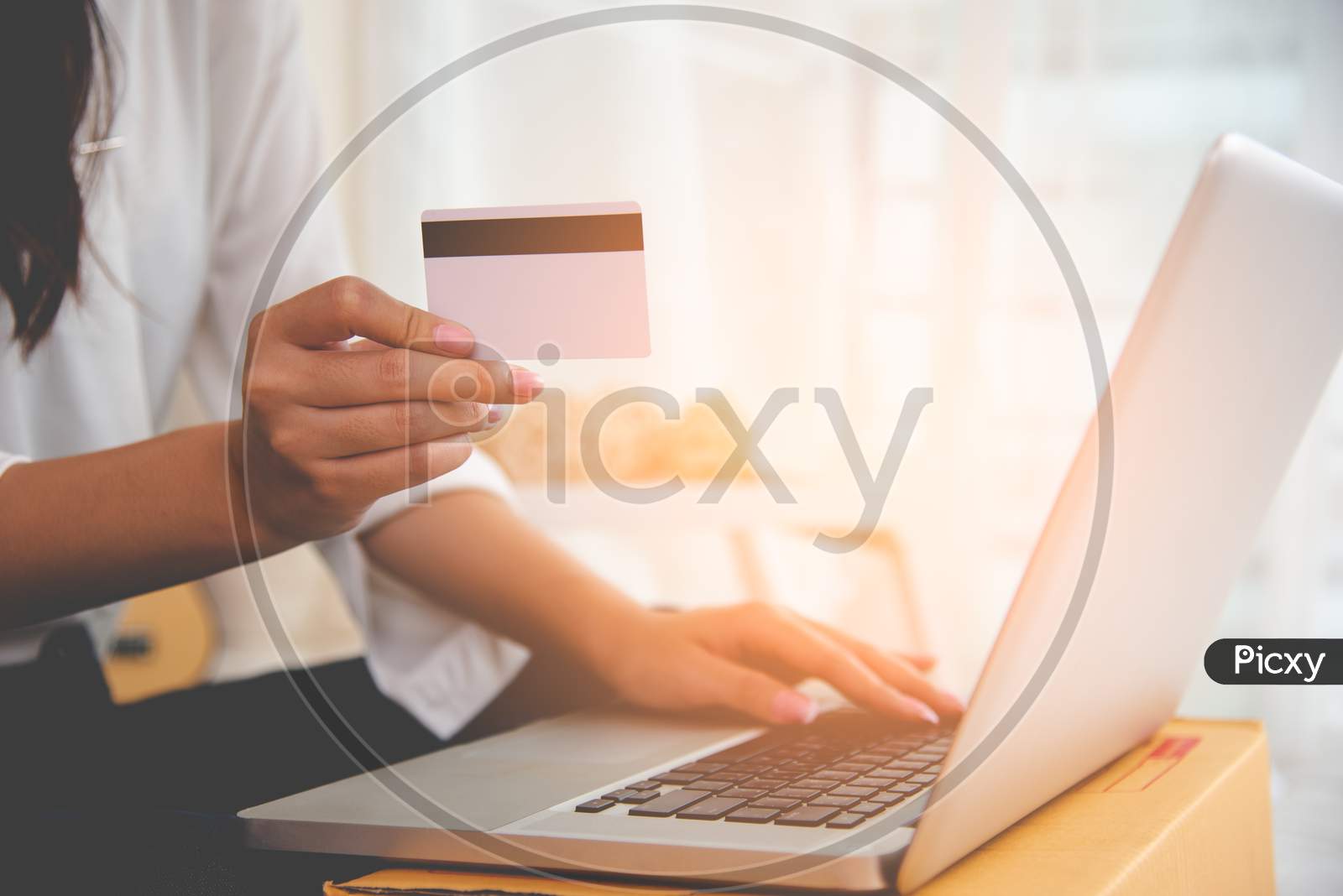 Close Up Hand Of Woman Using Credit Card For Online Shopping Payment With Laptop Computer. Technology And Business Concept.