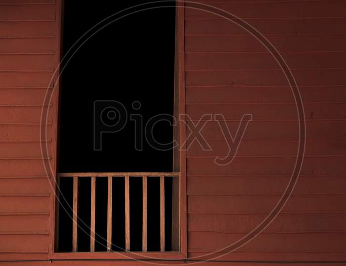 Wooden Balcony With Dark Room In Window. Thai Style House. Haunted House Background Concept.