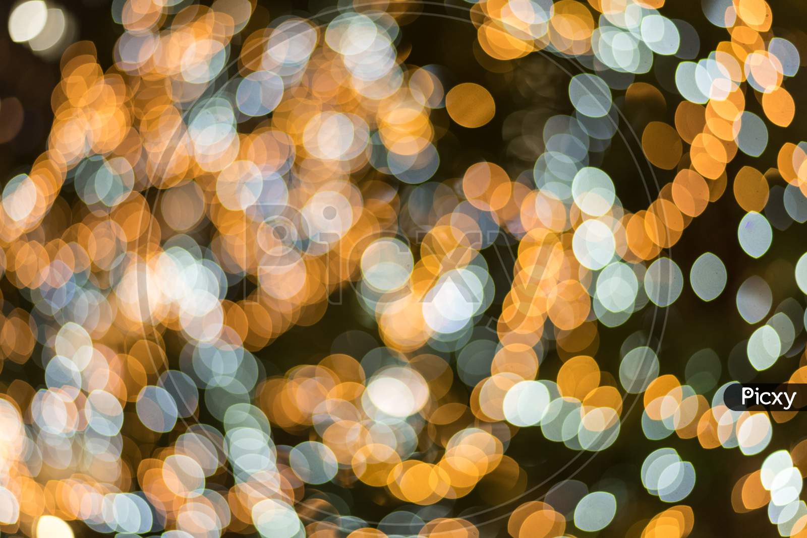 Blue And Yellow Abstract Blurry Light Bokeh Background For Overlay. Anniversary And Celebration Concept. New Year Festival And Christmas Event Theme