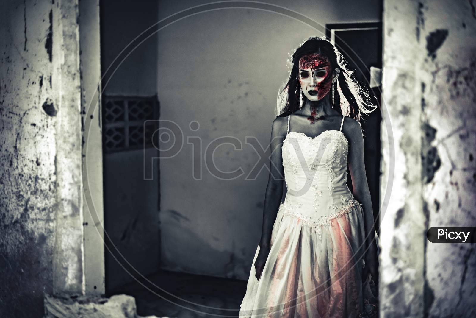 Female Zombie Corpse Standing In Front Of Grunge Wall In Abandoned House. Horror And Ghost Concept. Halloween Day Festival And Scary Movie Theme. Haunted House Theme. Dark Tone Film
