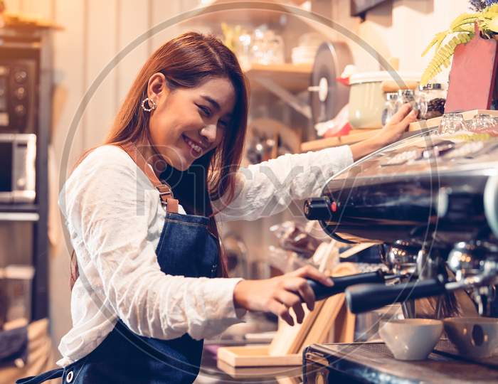 Professional Female Barista Hand Making Cup Of Coffee With Coffee Maker Machine In Restaurant Pub Or Coffee Shop. People And Lifestyles. Business Food And Drink Concept.  Happy Shop Owner Entrepreneur
