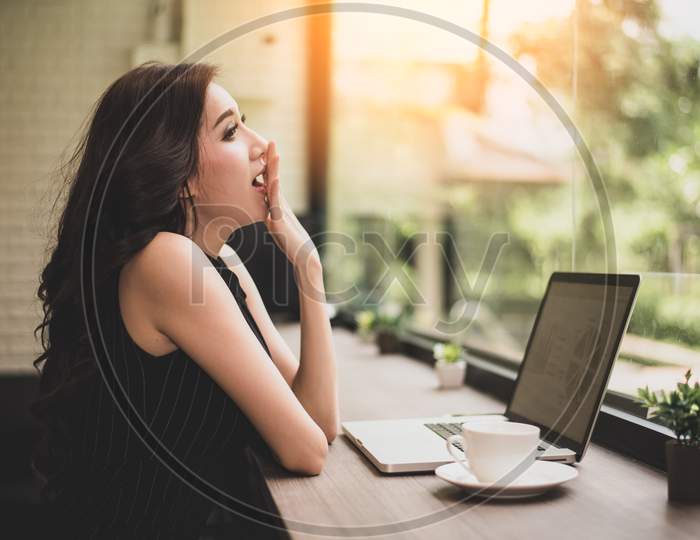 Working Woman Yawning In Workplace. Business And Lifestyle Concept. Technology And People Concept. Mood And Gesture Theme.