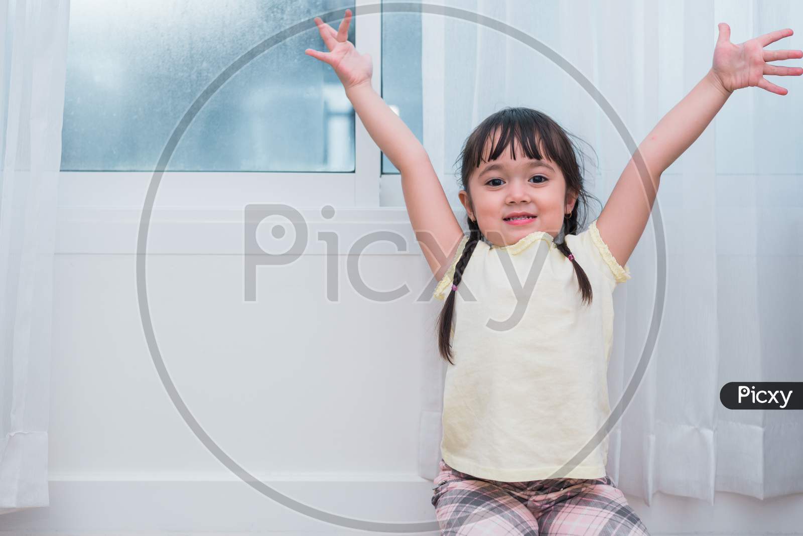 Little Girl Raise Hands With Happy Gesture Mood. Kids Play And Back To School Concept. Education And Portrait Theme. People And Lifestyle Theme.