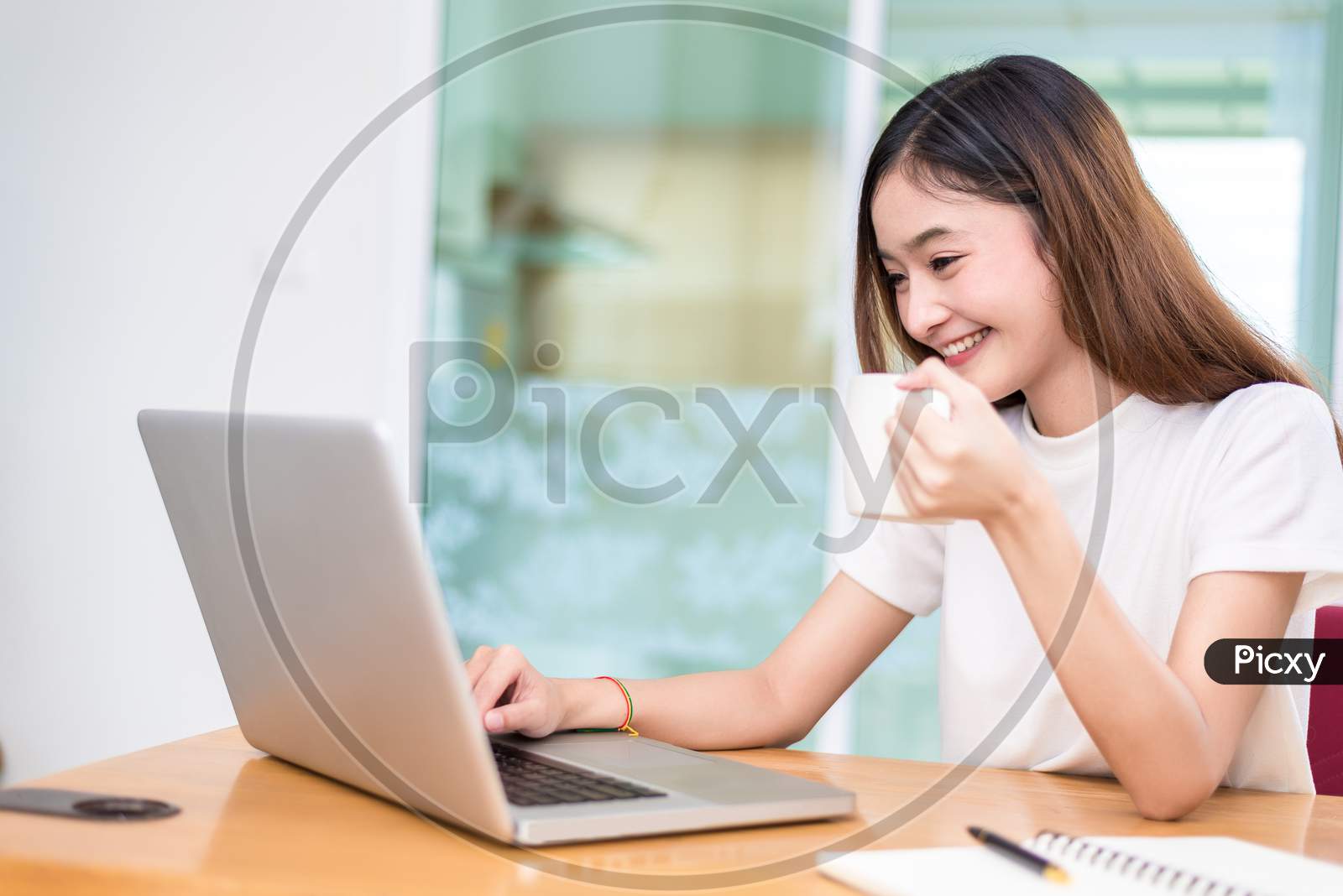 Asian Woman Enjoy Herself While Using Laptops And Internet In Office. Business And Marketing And Part Time Concept. On Line Shopping And Business Success Theme. Happy Mood Doing Working Job.