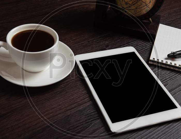 Tablet And Coffee Cup And Blank Notebook For Memo With Pen On Wooden Background. Business And Object Concept. Memo And Reminder Theme.