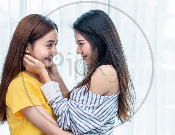 Two Asian Women Looking At Each Others In Home. People And Lifestyles Concept.  Lgbt Pride And Lesbian Theme.