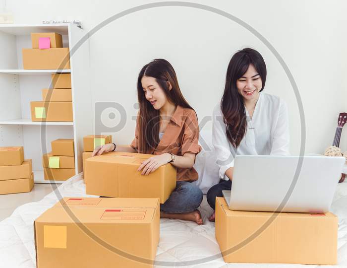 Young Asian Woman Startup Small Business Entrepreneur Sme Distribution Warehouse With Parcel Mail Box. Owner Home Office Concept. Online Marketing And Product Packaging And Delivery Service.
