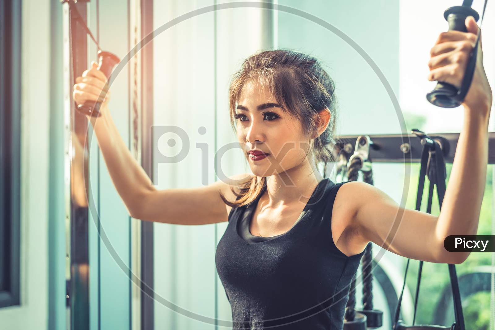 Asian Young Woman Doing Elastic Rope Exercises At Cross Fitness Gym. Strength Training And Muscular. Beauty And Healthy Concept. Sport Equipment And Sport Club Center Theme.