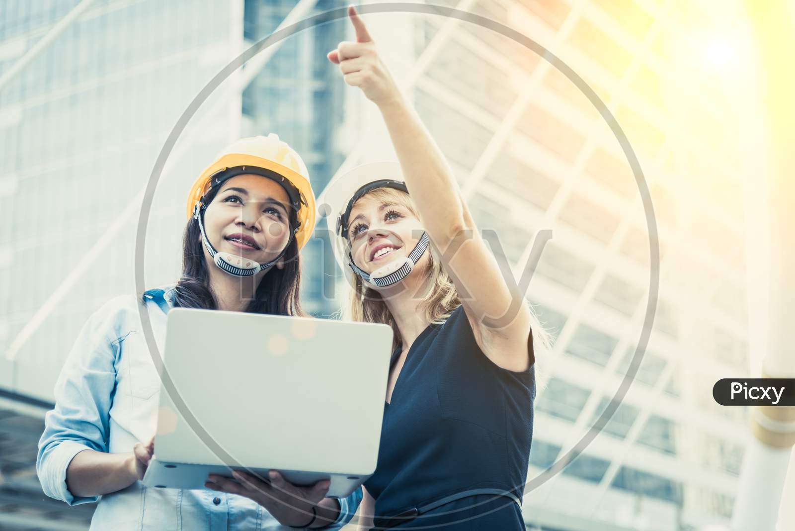 Two Women Engineering Surveying For Startup And Launching New Project. Building And Construction Concept. Business And Happiness Of Cooperation Concept. Civil Engineer Theme. City And Urban Theme