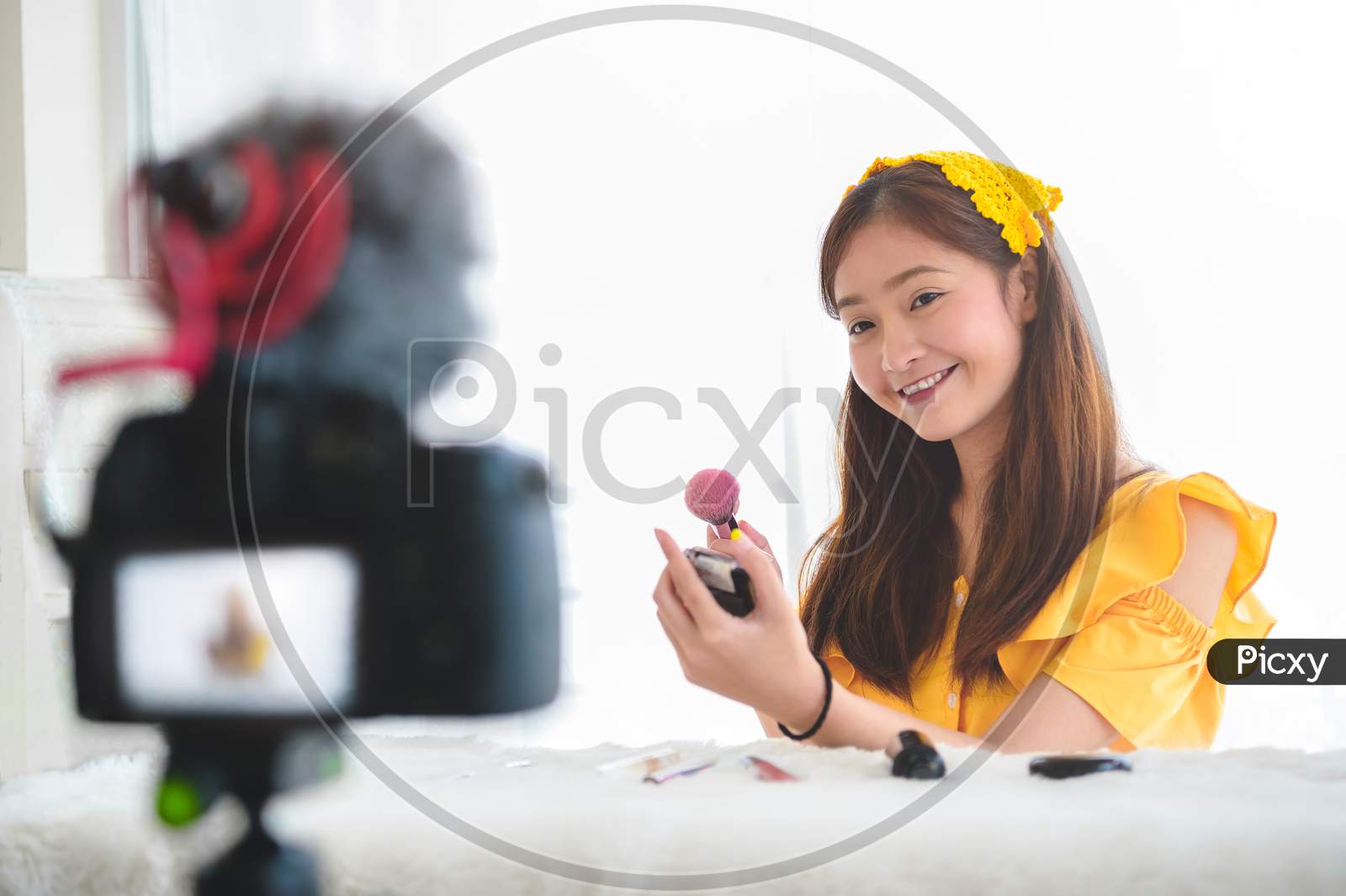 Happy Asian Young Beauty Blogger Girl Training How To Be Make Up Artist In Home Studio. Woman Speaking In Front Of Camera As Vlogger. Female Vlog Blogger Recording Video Tutorial Upload To Internet