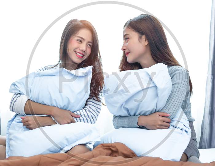 Image Of Two Asian Lesbian Women Looking Together In Bedroom Couple