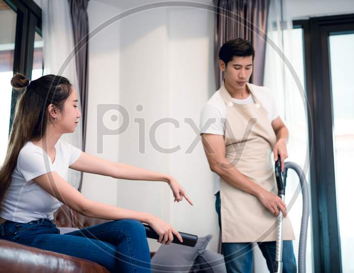 Girlfriend Force Ordering Boyfriend To Do Household Work By Vacuum Cleaner. Lovers And Couples Concept. Honeymoon And Wedding Theme. Interior And Dating Theme. Man Dissatisfy To Do Household Working