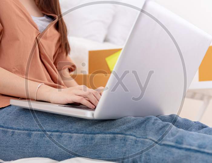 Closeup Of Laptop Using By Woman For Online Shopping Delivery Business At Home. Girl Typing On Keyboard By Hand. People Lifestyle And Occupation Concept. Entrepreneur Work From Home And Shop Owner