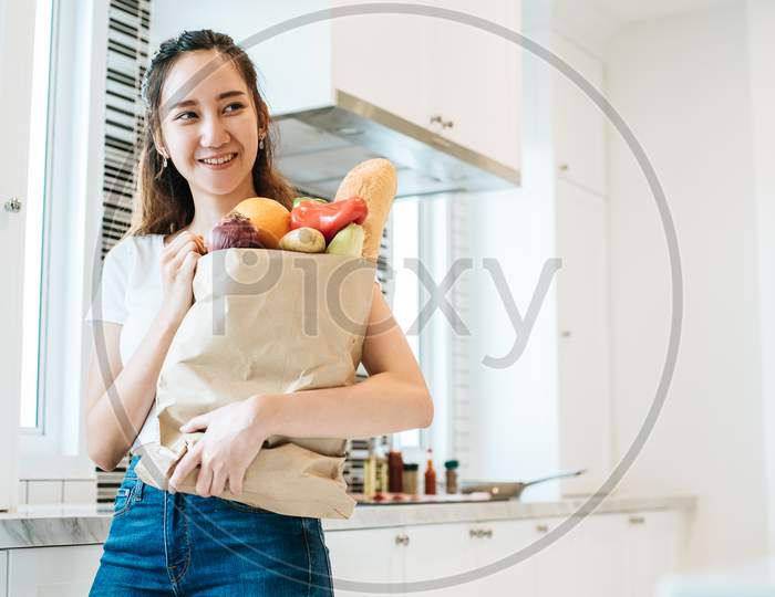 Asian Beauty Woman Holding Plenty Of Ingredients For Cooking After Shopping At Supermarket People And Lifestyles Concept. Food And Meal. Happiness Of Single Woman Theme. Dinner Party Theme.