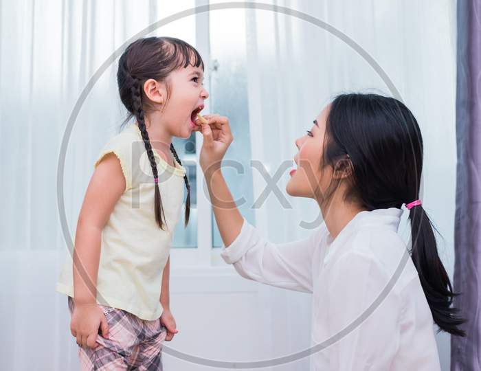 Mom Feeding Kids With Potato Chip. Teacher Feeding Student With Snack. Back To School And Education Concept. Children And Kids Theme. Home Sweet Home And Nursery Theme.