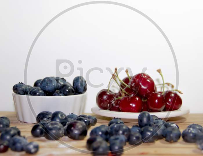 Red Fruits With Rustic Wood Background