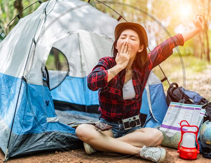 Beauty Asian Women Are Yawning While Traveling Overnight. People And Lifestyles Concept. Leisure And Activity Concept. Camping And Adventure Theme.