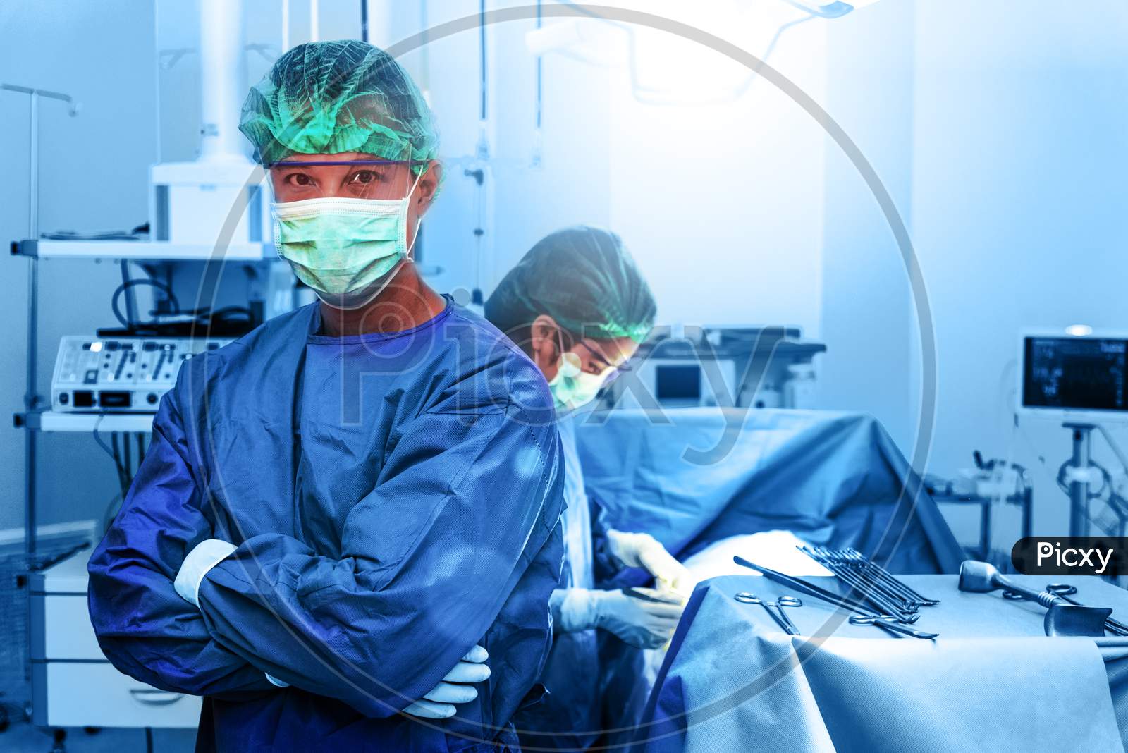 Professional Doctor And Nurse In Operation Room. Portrait And Healthcare Concept. Teamwork And Success Concept.Working People In Hospital And Plastic Surgery For Beauty Theme. Blue Filter Background.