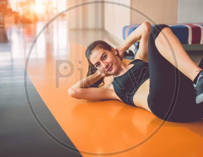 Sport Woman Doing Sit Up In Fitness Sport Training Club With Sport Equipment And Accessories Background. Workout Crunch And Bodybuilder. Lifestyles Leisure And Indoors Activity. Cardio Program Concept