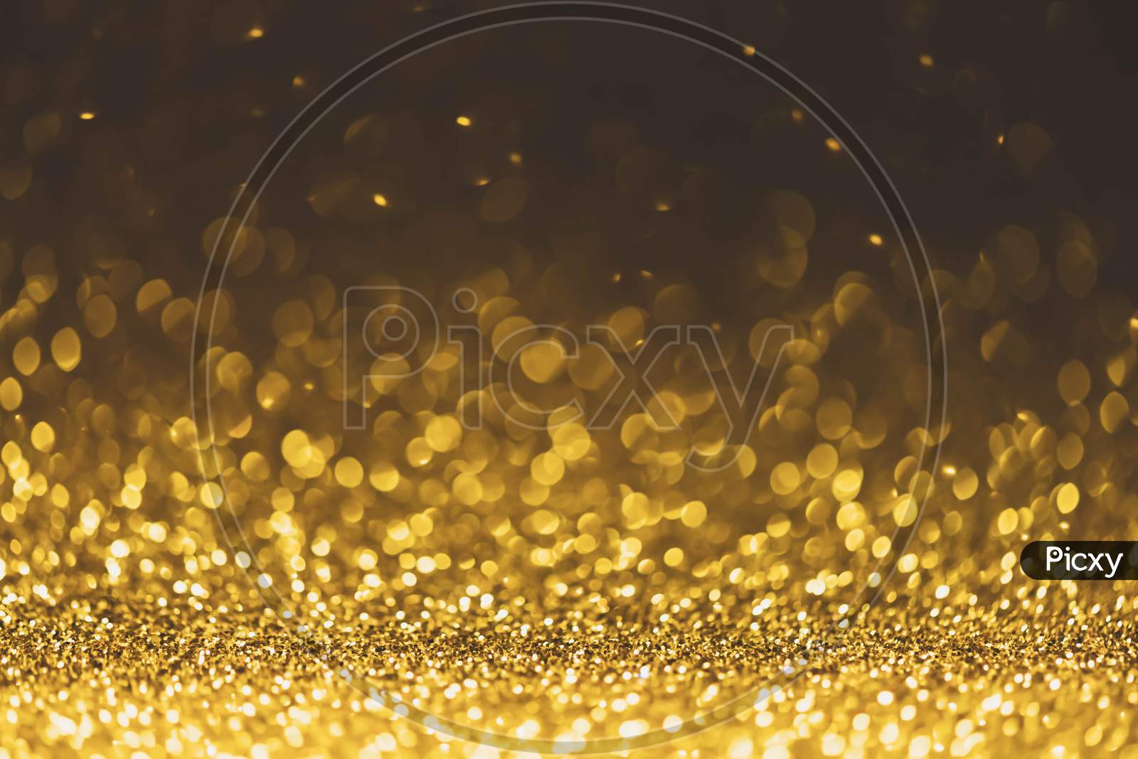 Gold Glitter Sparkle Lights Background. Defocused Glitter Abstract Twinkly Light And Shiny Stars. Christmas And New Year Party Concept Background. Closeup Stardust.