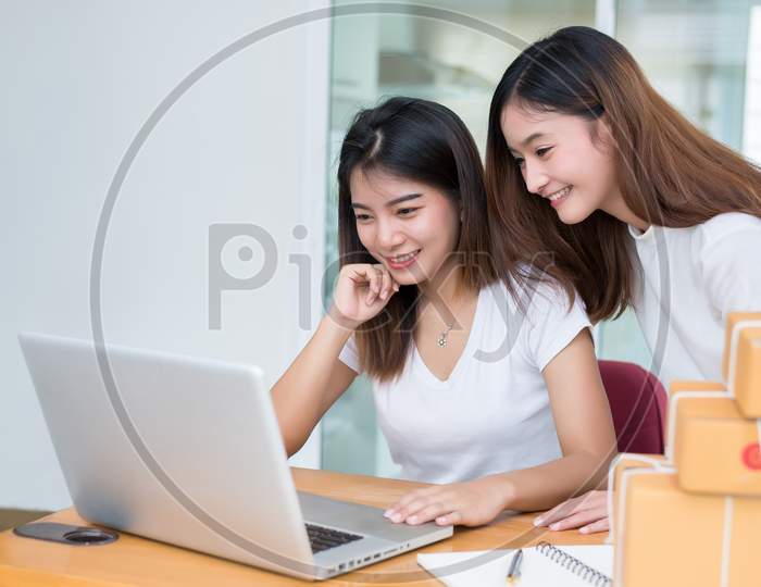 Two Young Happy Asian People Startup Small Business Entrepreneur By Affiliate Drop Shipping Warehouse With Parcel Mail Box. Online Shopping Marketing And Product Packaging And Delivery Service Retail