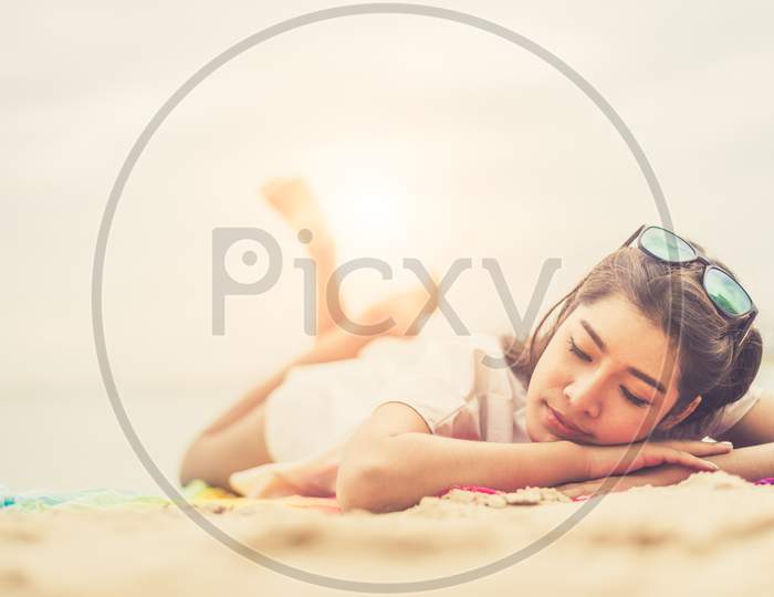 Beauty Woman Lying On Beach. Sea And Ocean Background People And Lifestyles Concept. Vacation And Relaxation Theme. Summer Seasonal Theme.