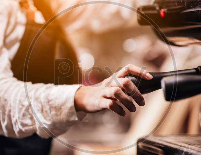 Closeup Of Professional Female Barista Hand Making Cup Of Coffee With Coffee Maker Machine In Restaurant Or Coffee Shop. People And Lifestyles. Business Food And Drink Concept. Shop Owner Theme