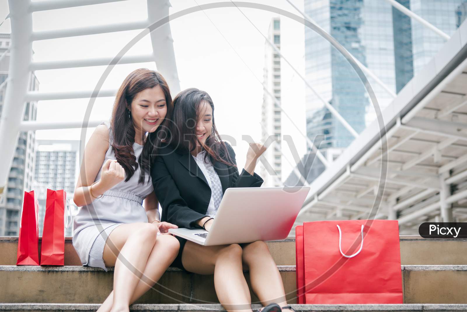 Two Businesswomen Online Shopping Laptop Computer With Successful Emotion. Business Entrepreneur Using Internet And Making Homepage For Sell Digital Product Technology Collaboration Community.