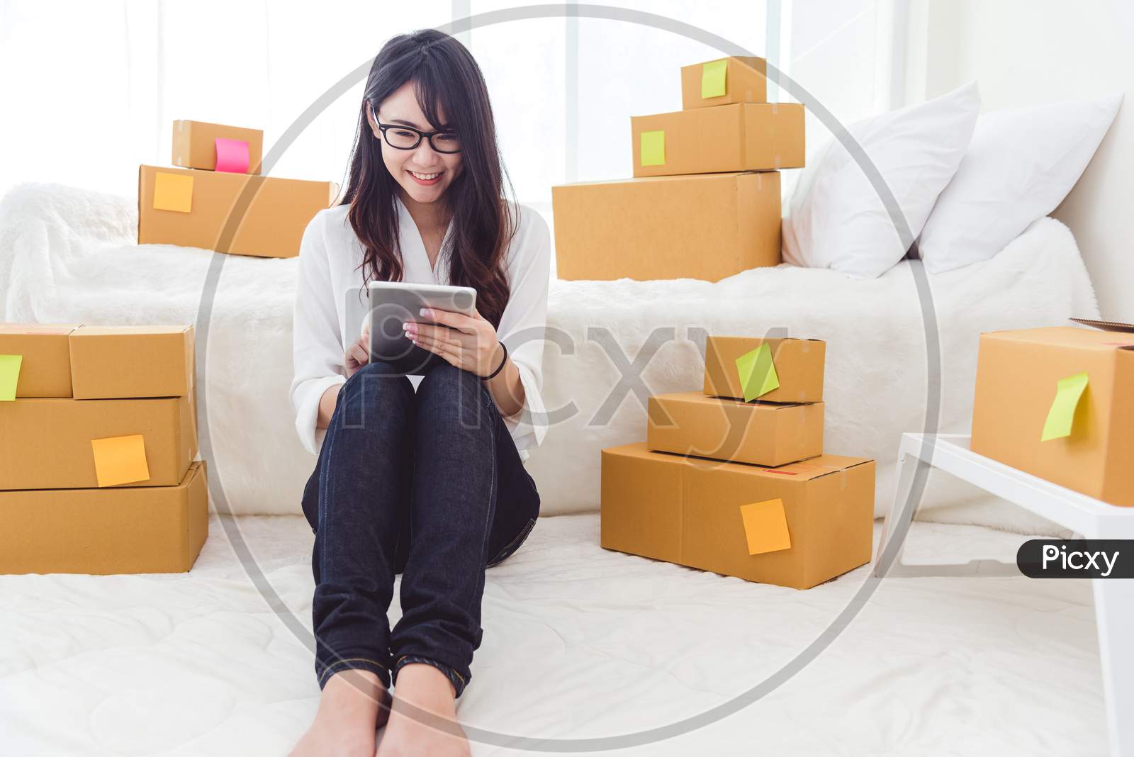 Beauty Asian Woman Using Tablet And Start Up Small Business Entrepreneur Sme And Checking Order List In Bedroom, Young Happy Freelance Woman Shopping Online Marketing Or Sending Parcel To Customers